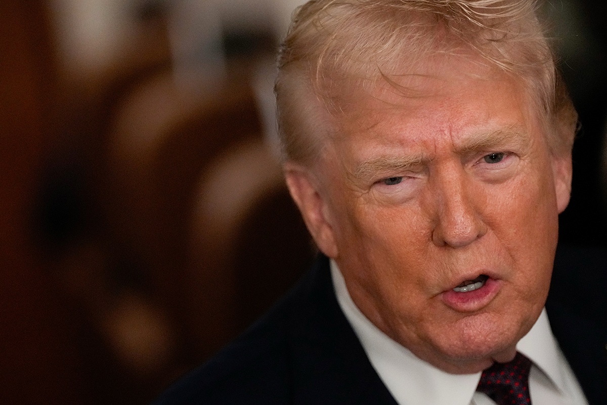 President Donald Trump speaks to reporters while in flight on Air Force One to Joint Base Andrews, Md., Sunday, Jan. 11, 2026.