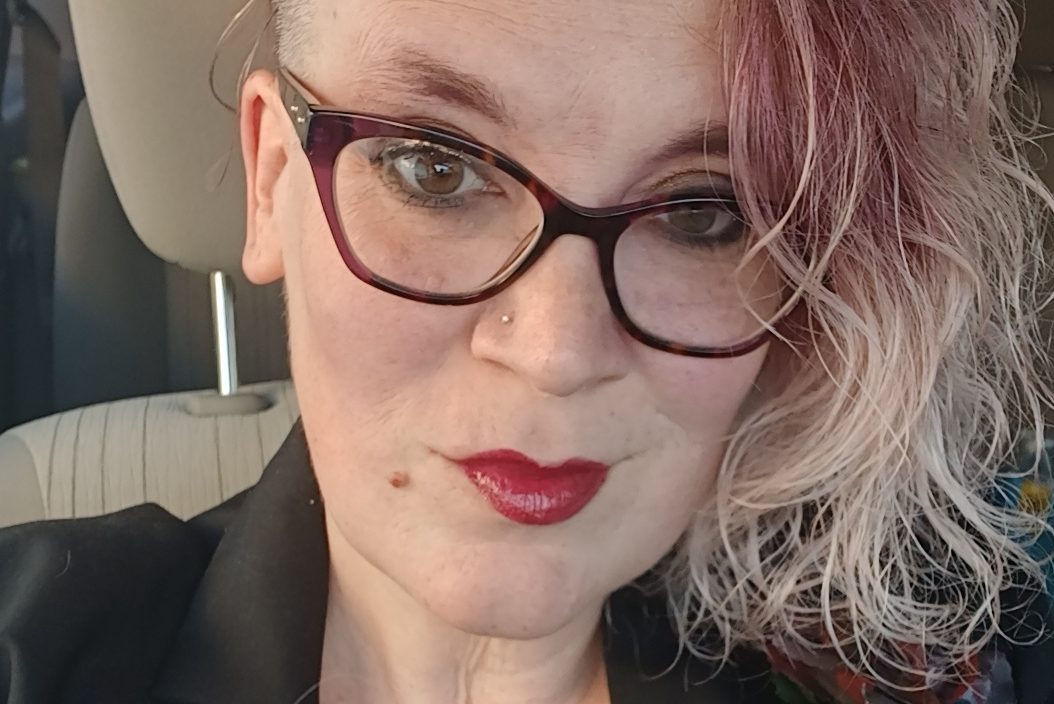 Headshot of a woman seated in a car