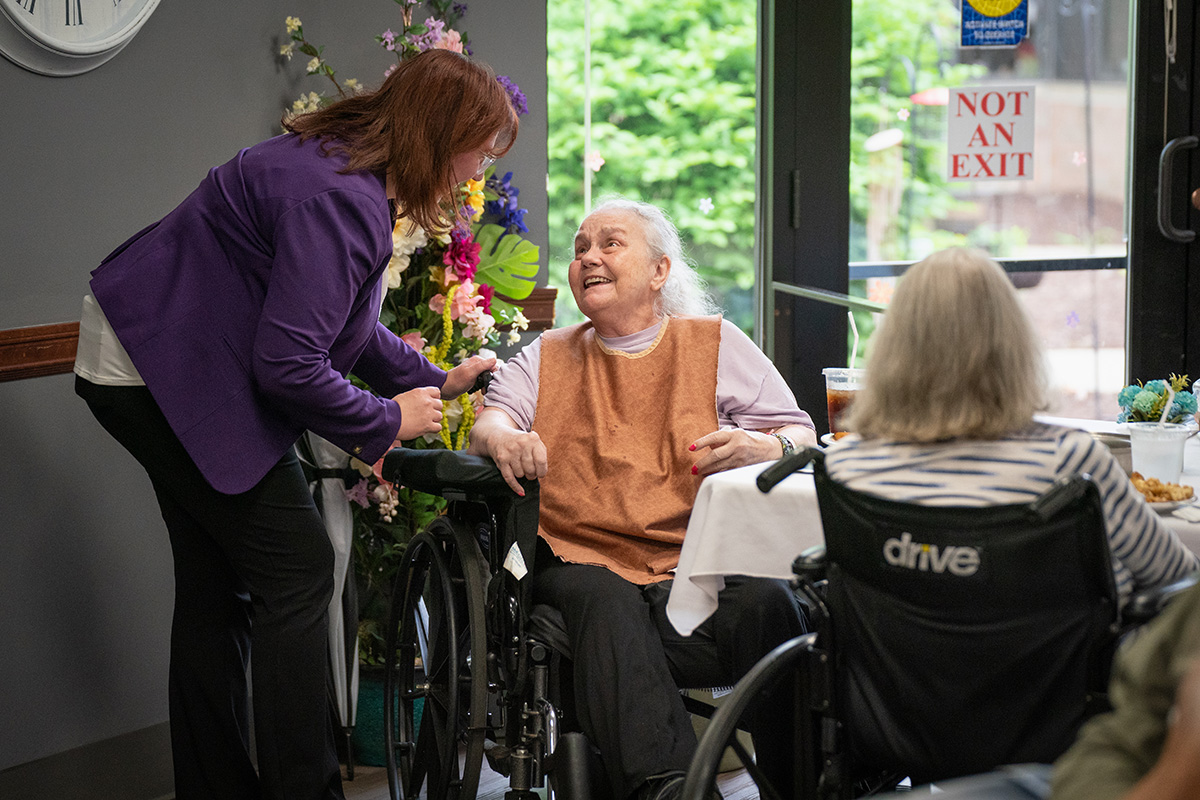 Destiny Wilkins, LNHA, CEO/Administrator at the Jackson County Medical Care Facility visits with residents during lunch.