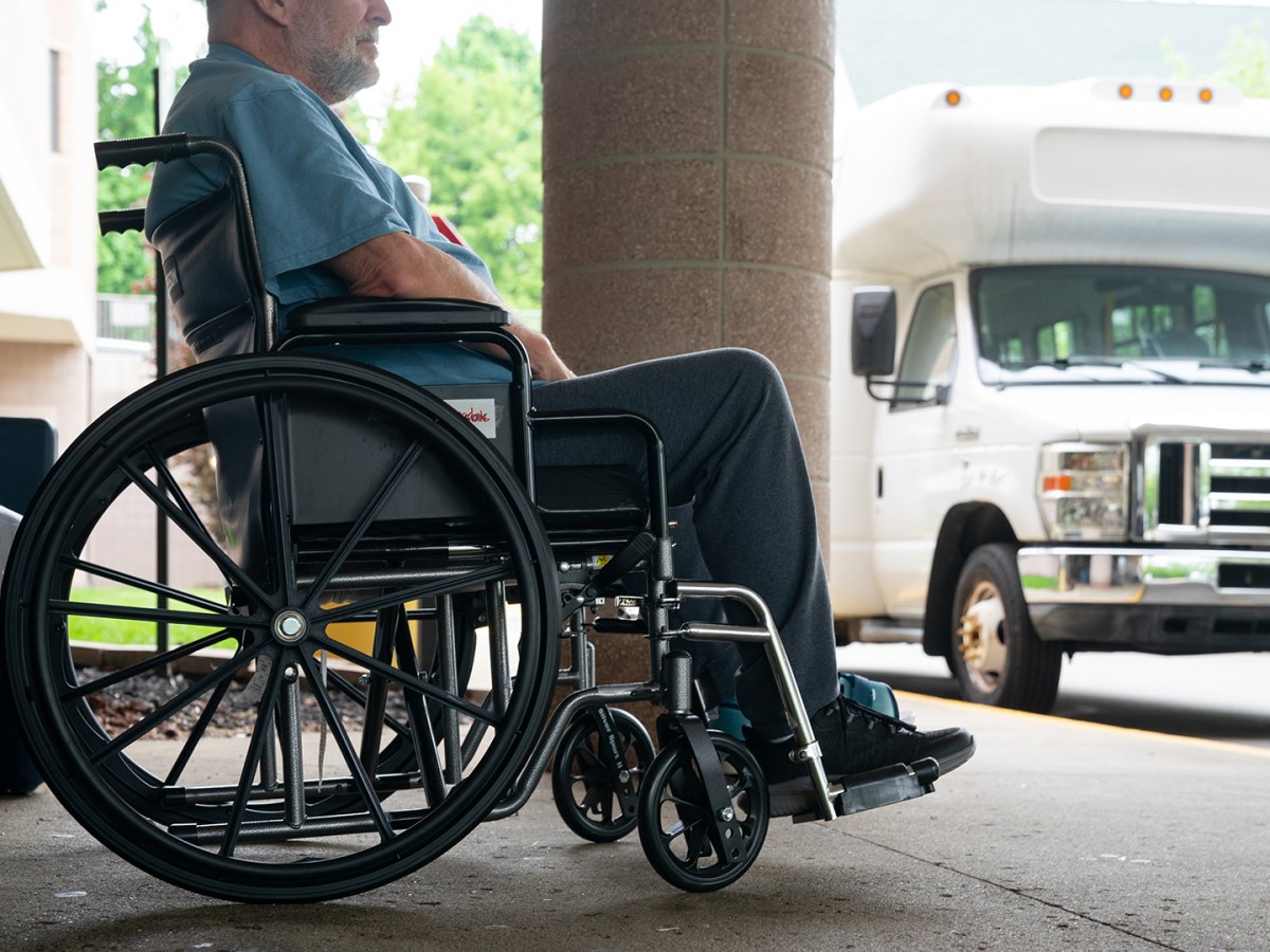 A resident of the Jackson County Medical Care Facility in Jackson Michigan waits outside the facility for transportation.