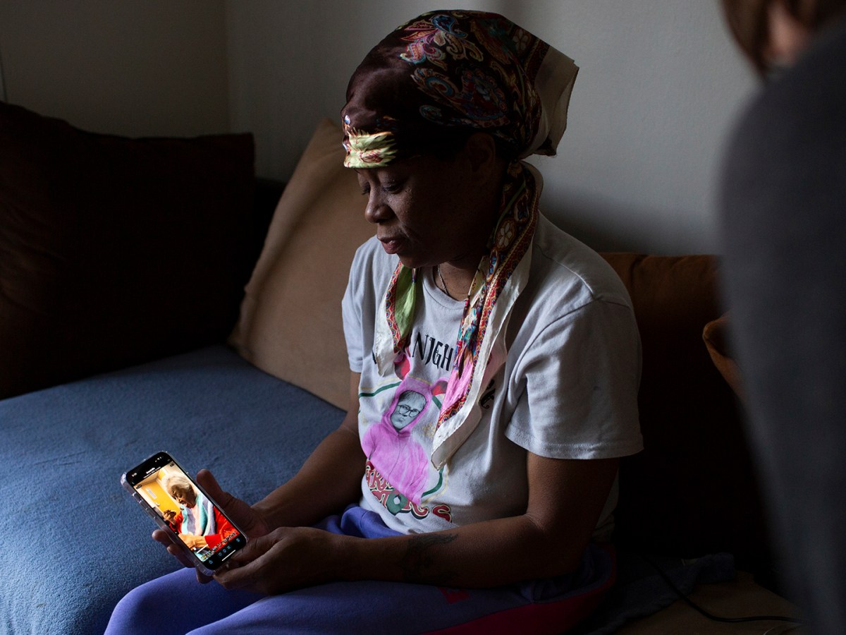 Angelique Thomas is seen showing a video of her mother to reporter Robin Erb at her home on Thursday, Spetember 11, 2025 in Grand Rapids, MI.
