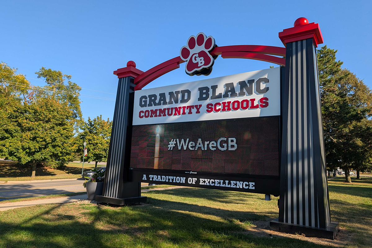 A sign outside of Grand Blanc Community Schools says "#WeAreGB."