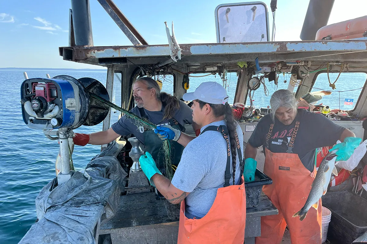 Fishermen work on a boat