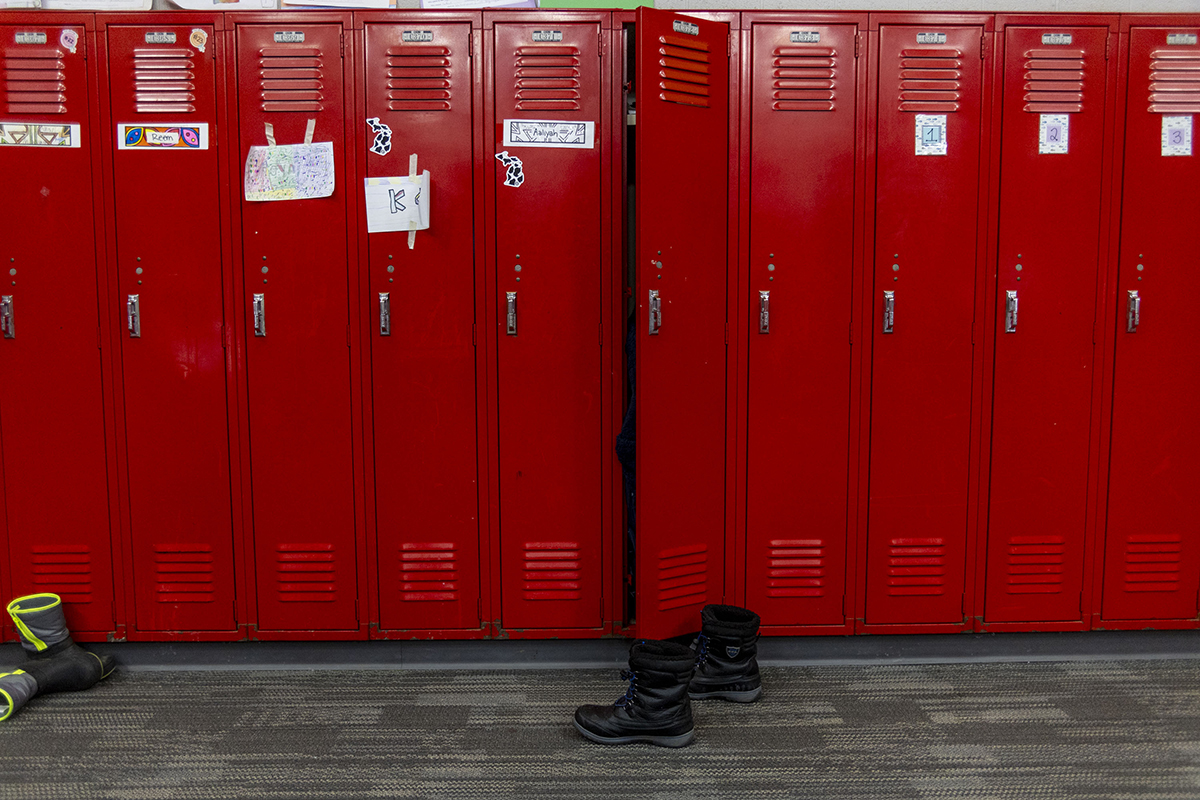 Red lockers in a hallway.