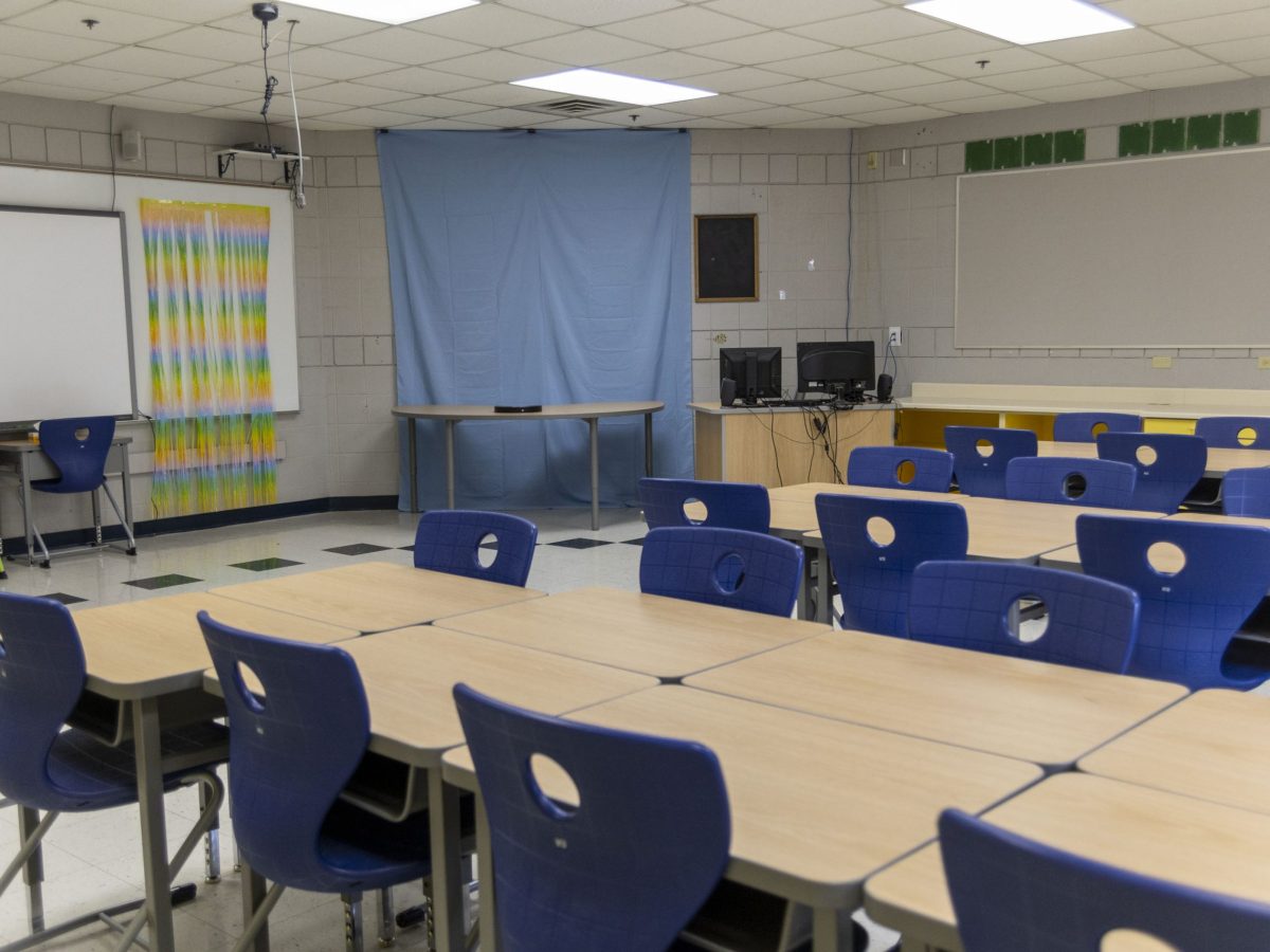 Blue chairs and desks in an empty classroom