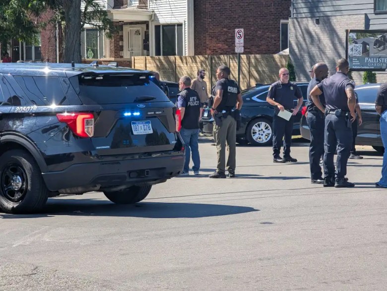 Police vehicles and officers are at the scene of the shooting.