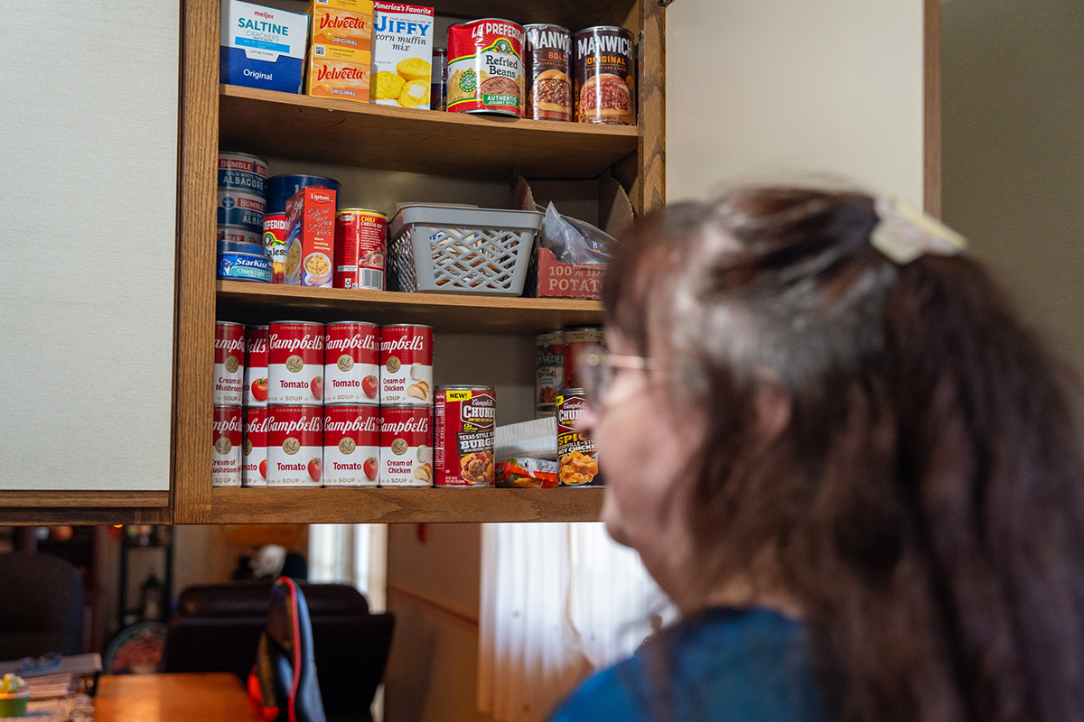Nancy Howard checks the pantry at a group home in Washington Township, MI.