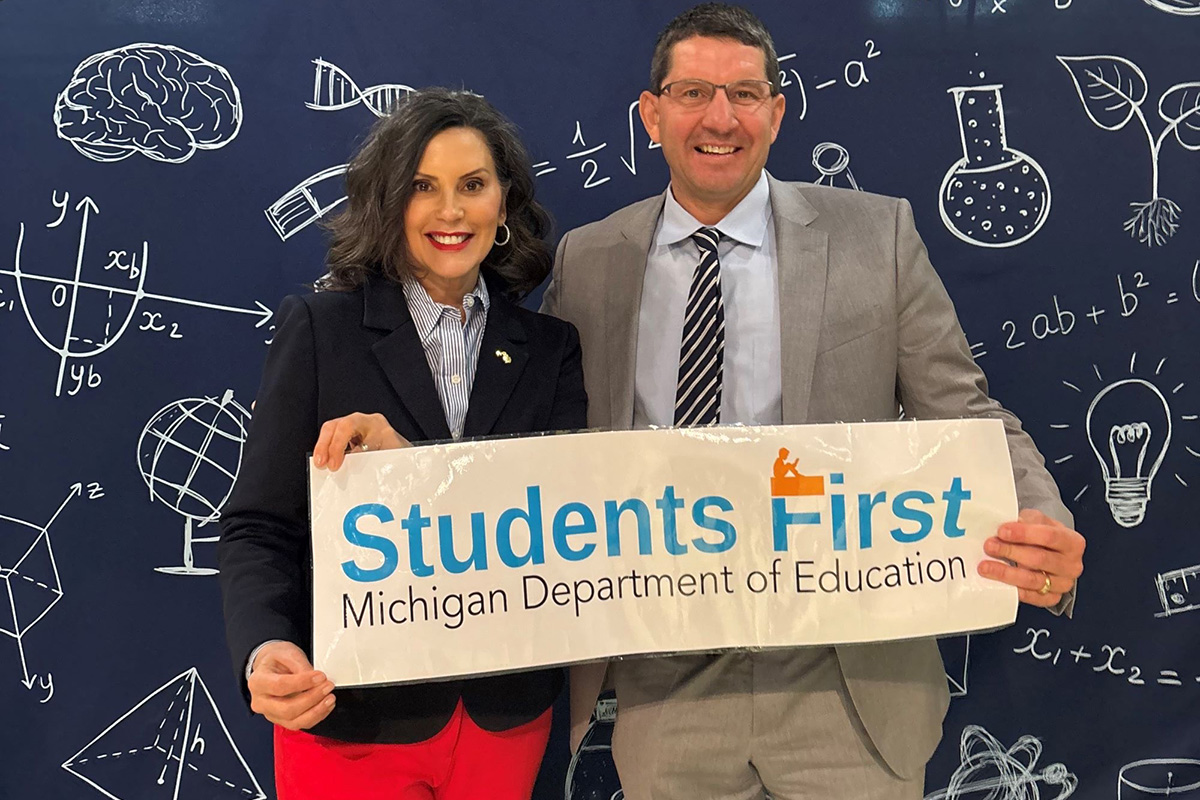 Gov. Gretchen Whitmer and Glenn Maleyko hold sign that says "Students First."