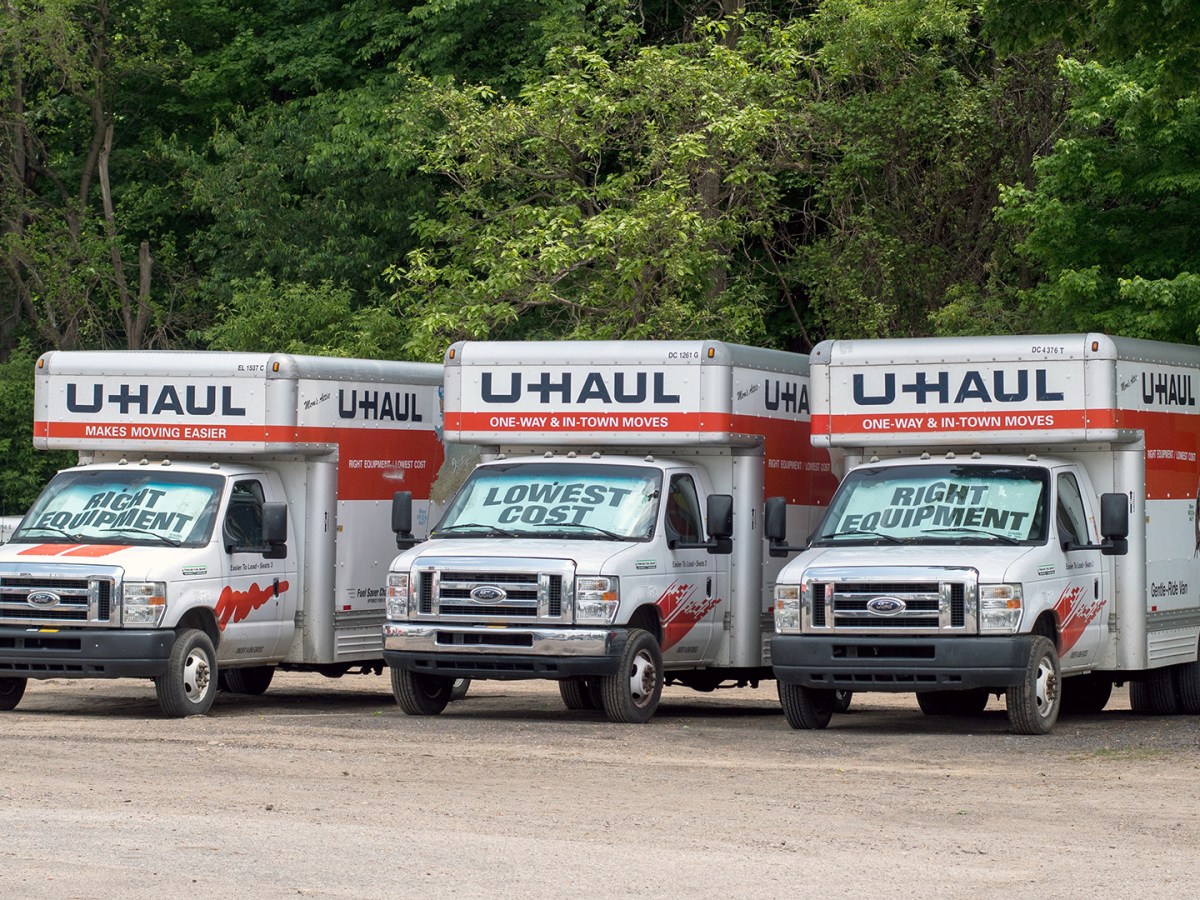 Rows of U haul trailers are parked at a distribution center, waiting to be rented