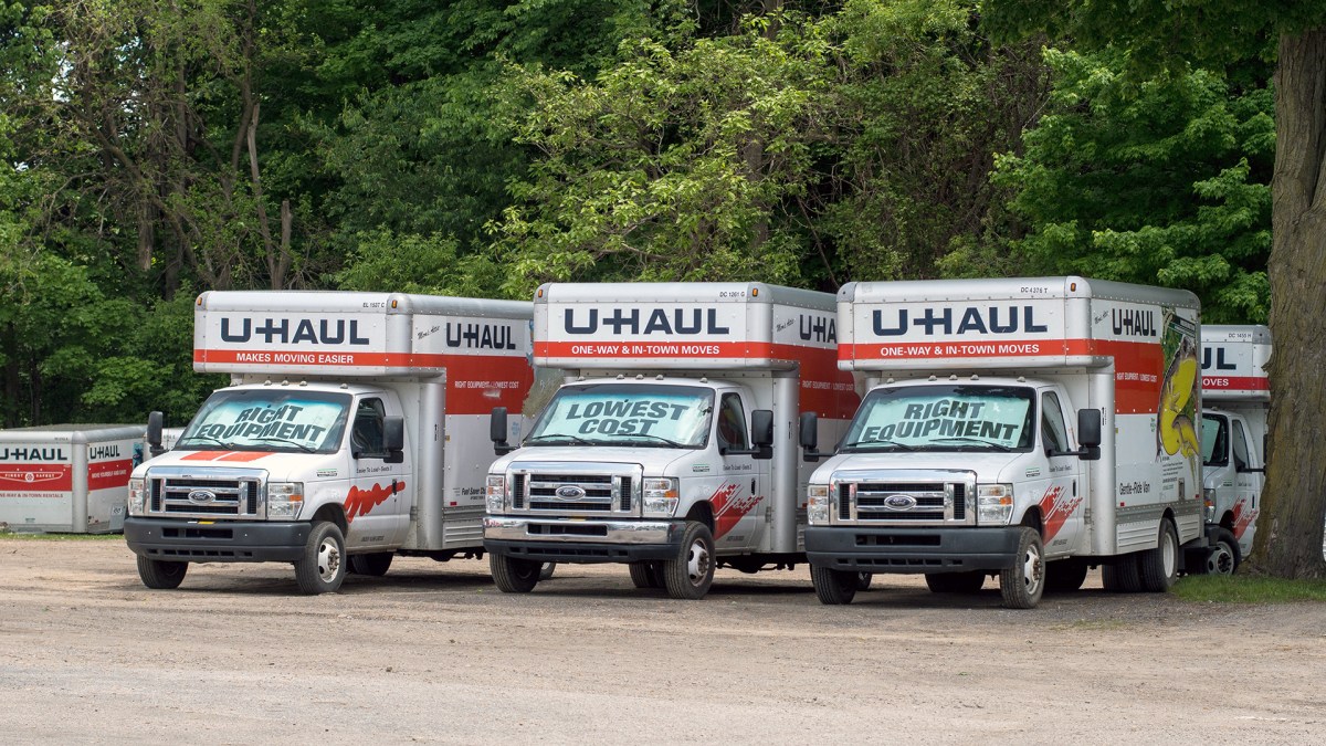 Rows of U haul trailers are parked at a distribution center, waiting to be rented