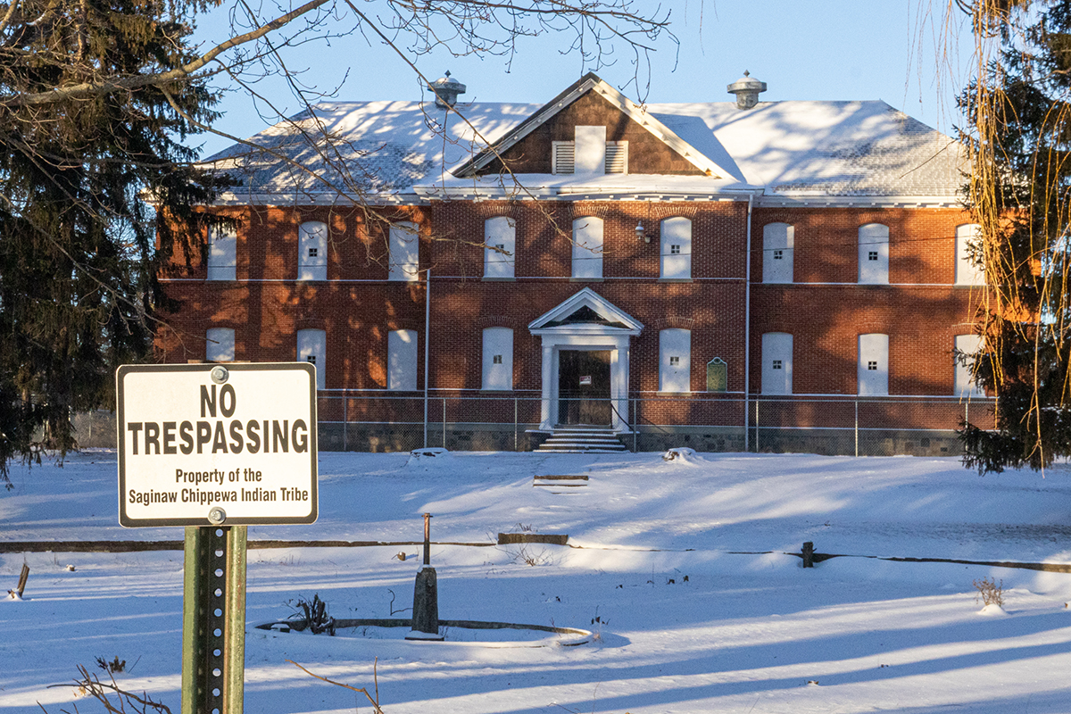 A no trespassing sign stands in front of a boarded-up schoolhouse on the campus of the Mount Pleasant Indian Industrial Boarding School on Tuesday, Jan. 20, 2026.