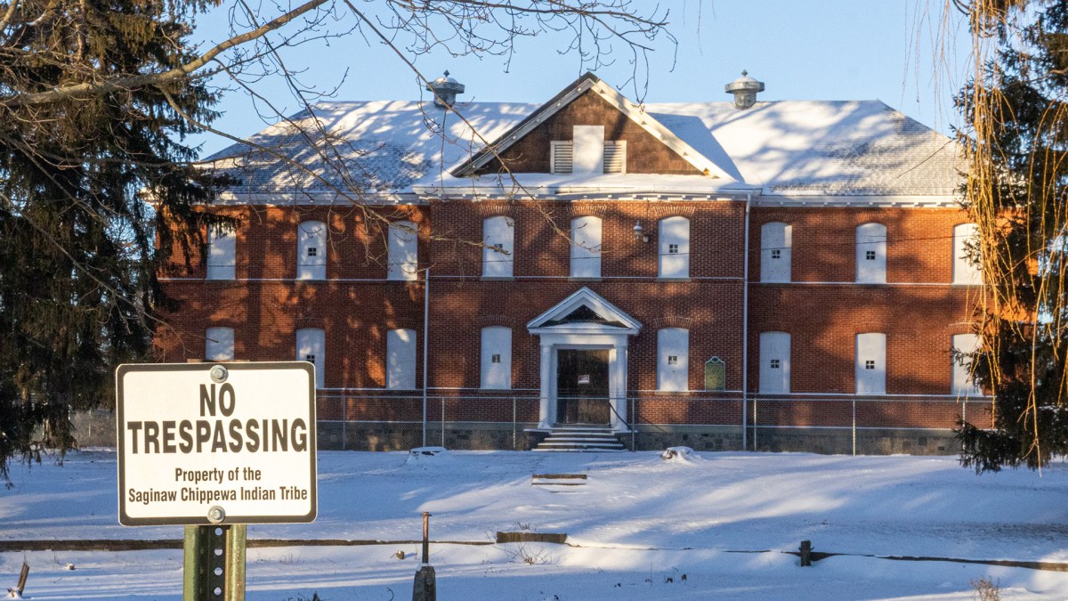 A no trespassing sign stands in front of a boarded-up schoolhouse on the campus of the Mount Pleasant Indian Industrial Boarding School on Tuesday, Jan. 20, 2026.