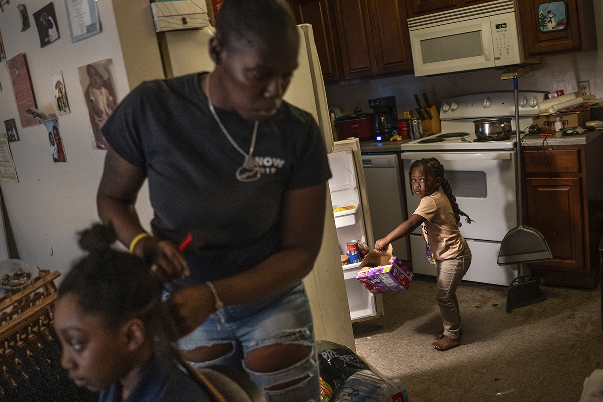 A mom and her daughters in the kitchen