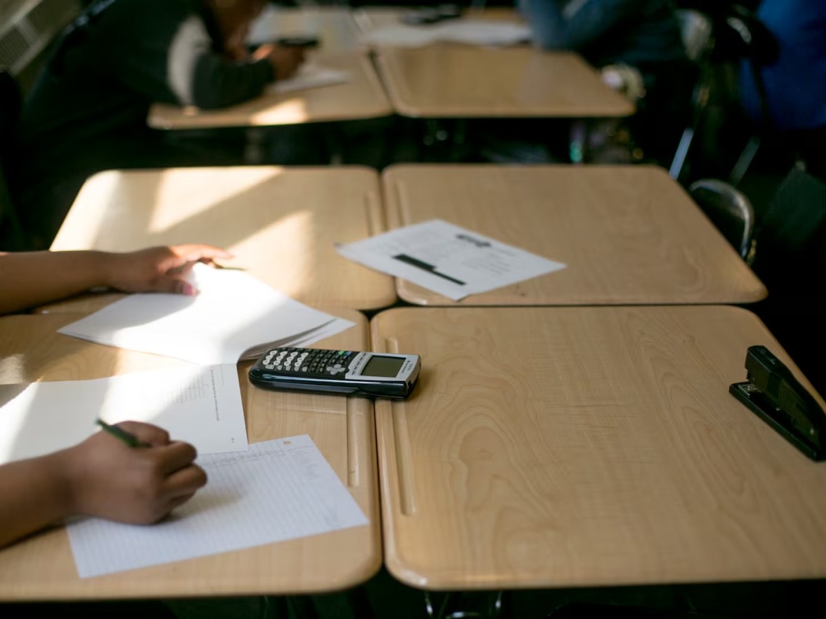 A student working on a math problem in a classroom