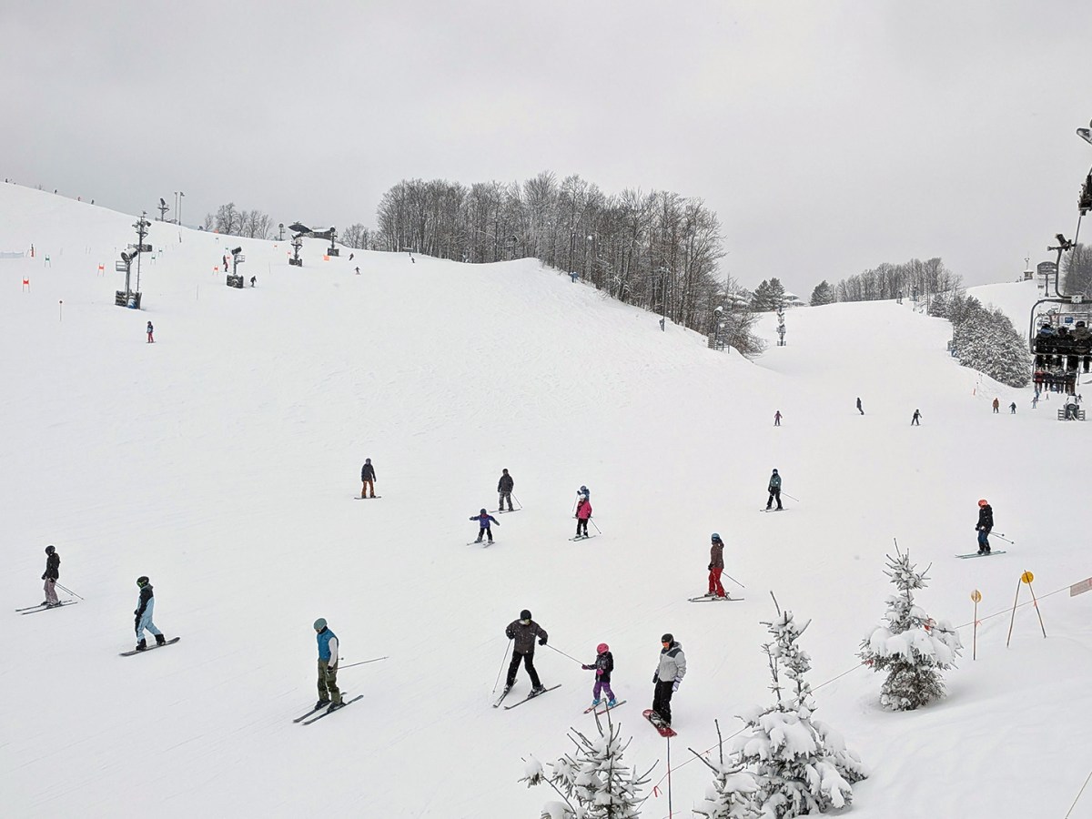 Skiers on a snowy Crystal Mountain in Thompsonville, Michigan.