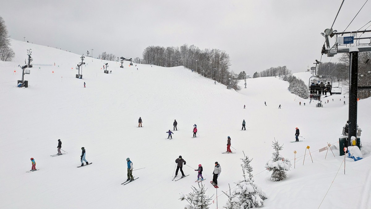 Skiers on a snowy Crystal Mountain in Thompsonville, Michigan.