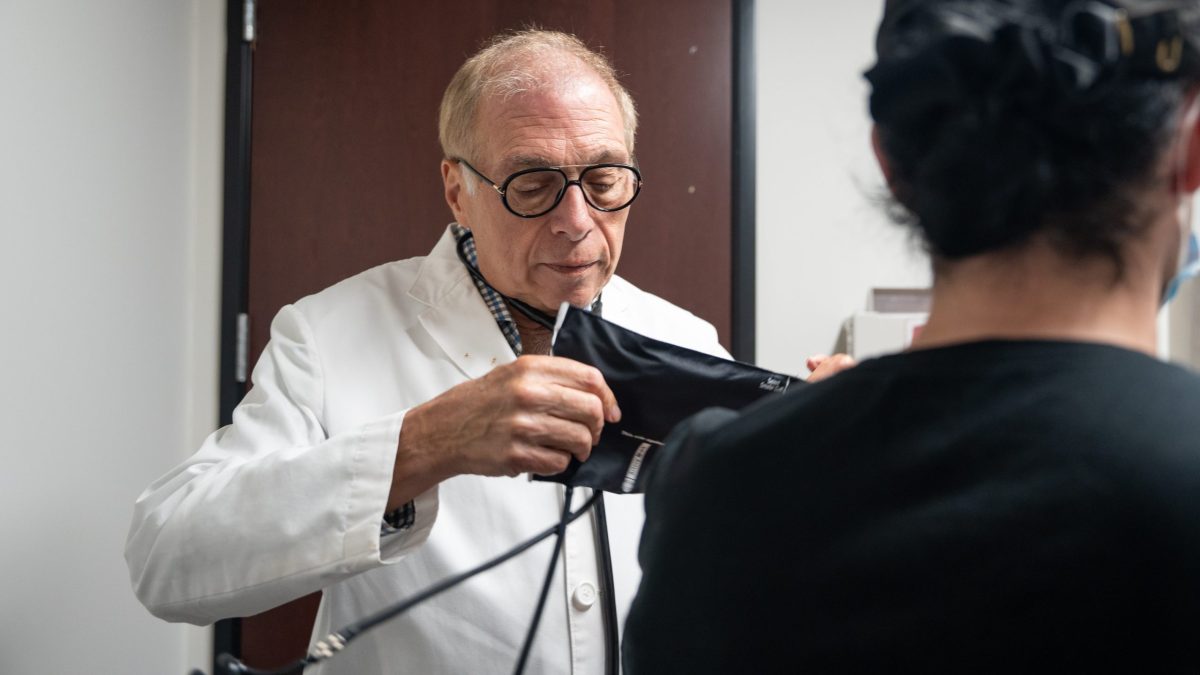 Dr. Paul Benson performs a routine physical exam on a patient at Be Well Medical Center in Berkley, Mich.