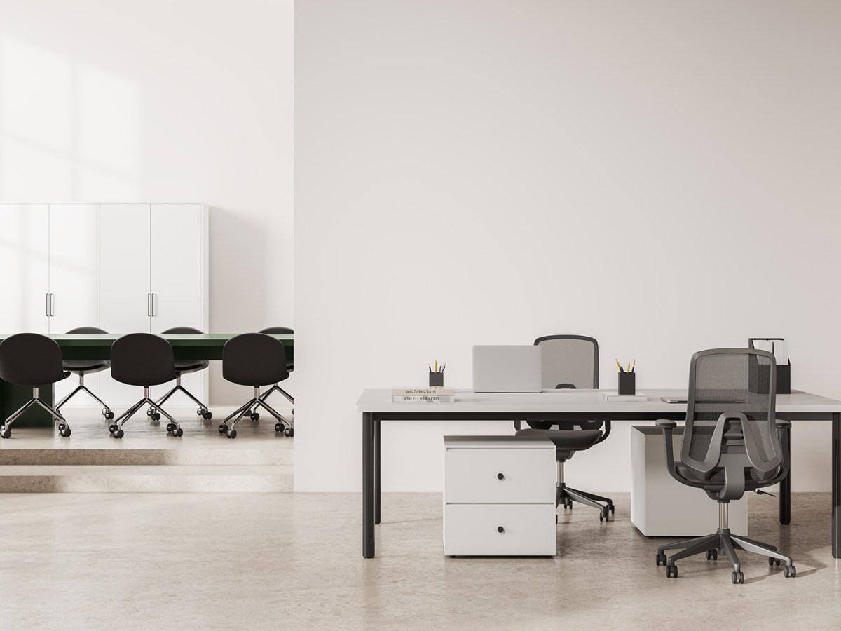 Interior of modern office meeting room with white walls, concrete floor, long green conference table with chairs and computer desk standing near copy space wall. 3d rendering