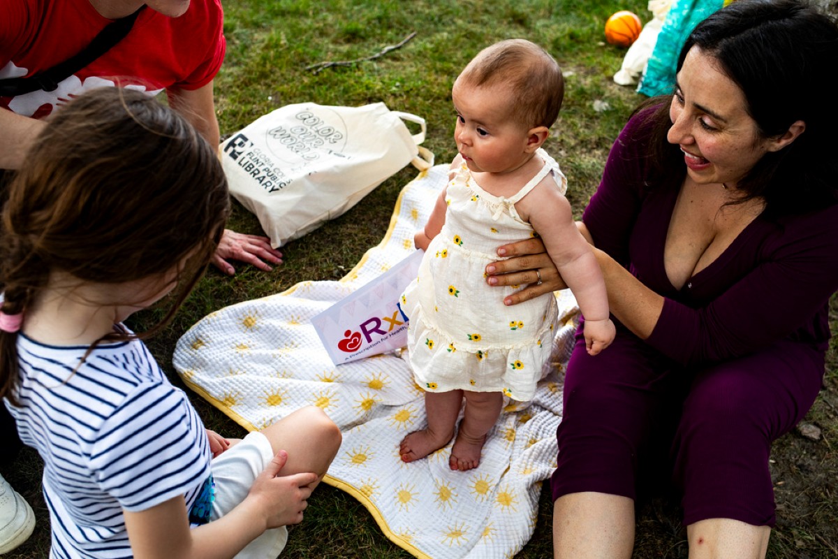 Woman holding baby on the ground