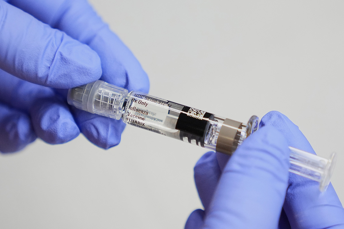 A certified medical assistant holds a syringe for a flu vaccine at a clinic in Seattle, on Wednesday, Sept. 10, 2025.