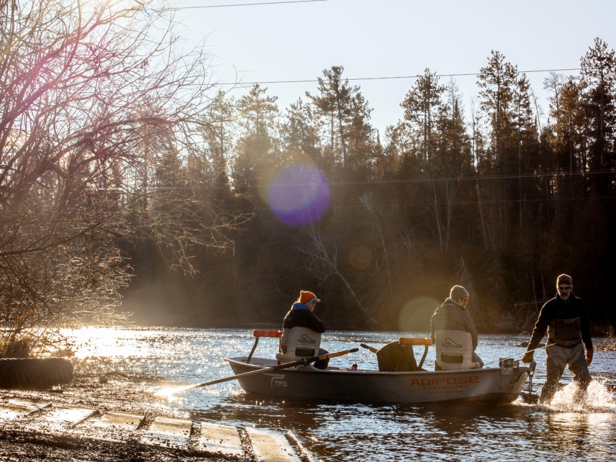 People on a boat go out into a river