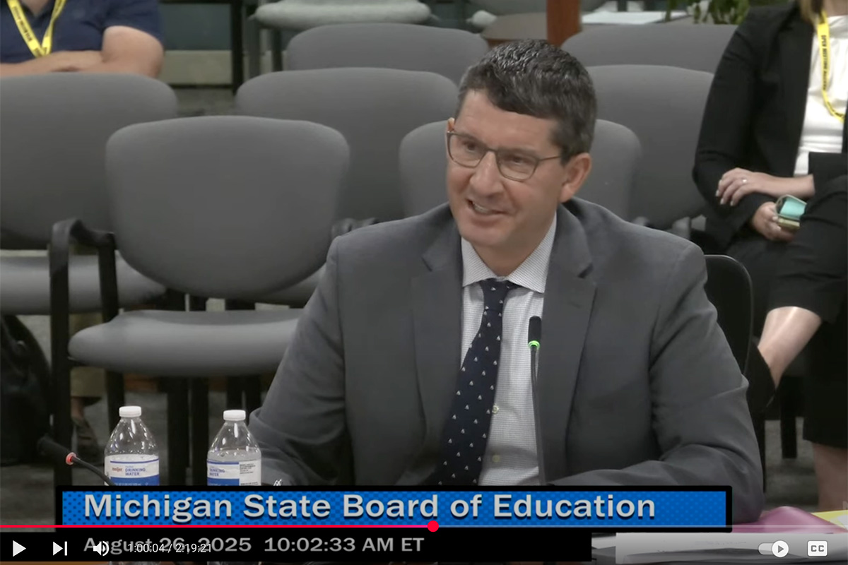 A screenshot of Glenn Maleyko in a grey suit.