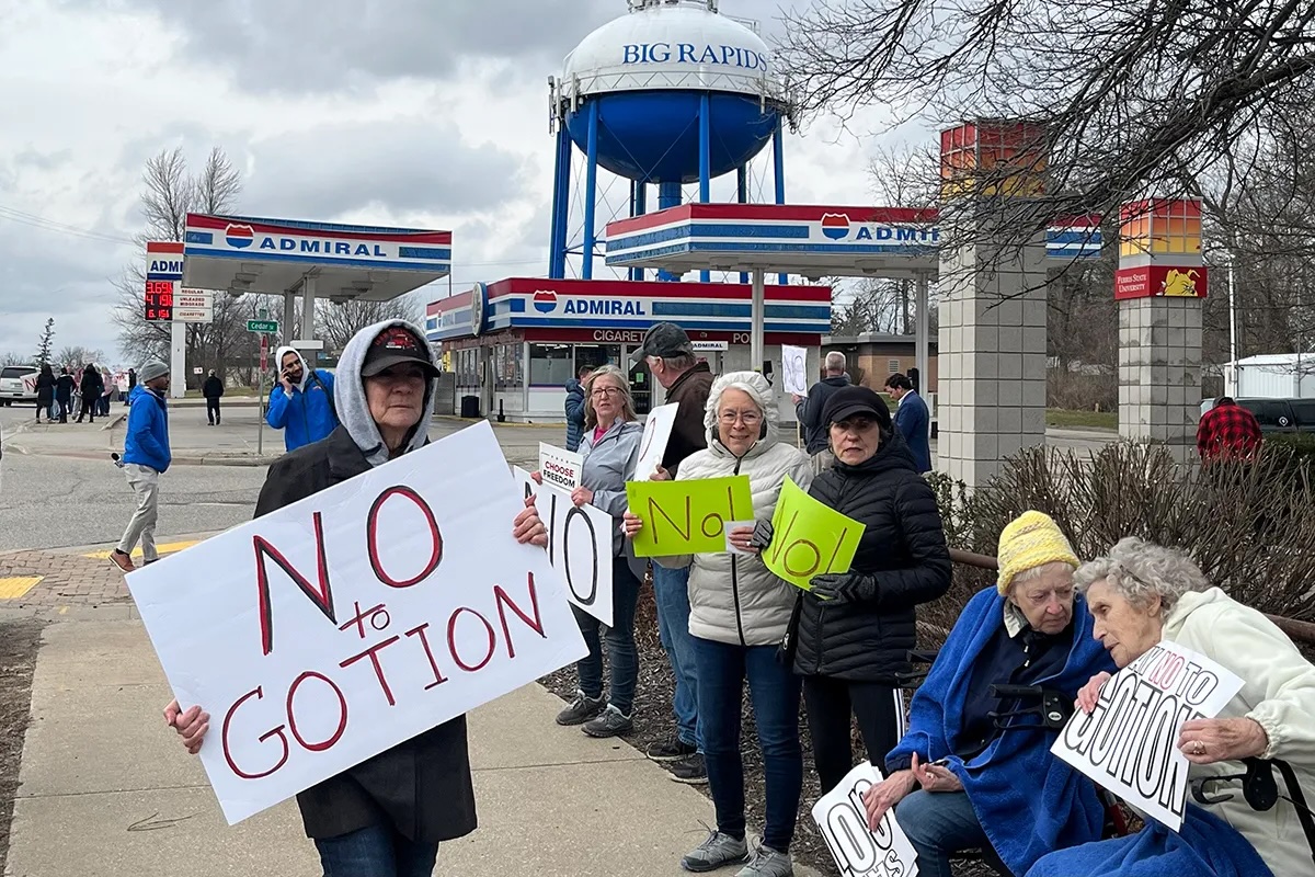 Protestors holding "No Gotion" sign.