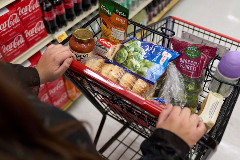 A food shopper pushes a cart of groceries at a supermarket in Bellflower, Calif., on Monday, Feb. 13, 2023.