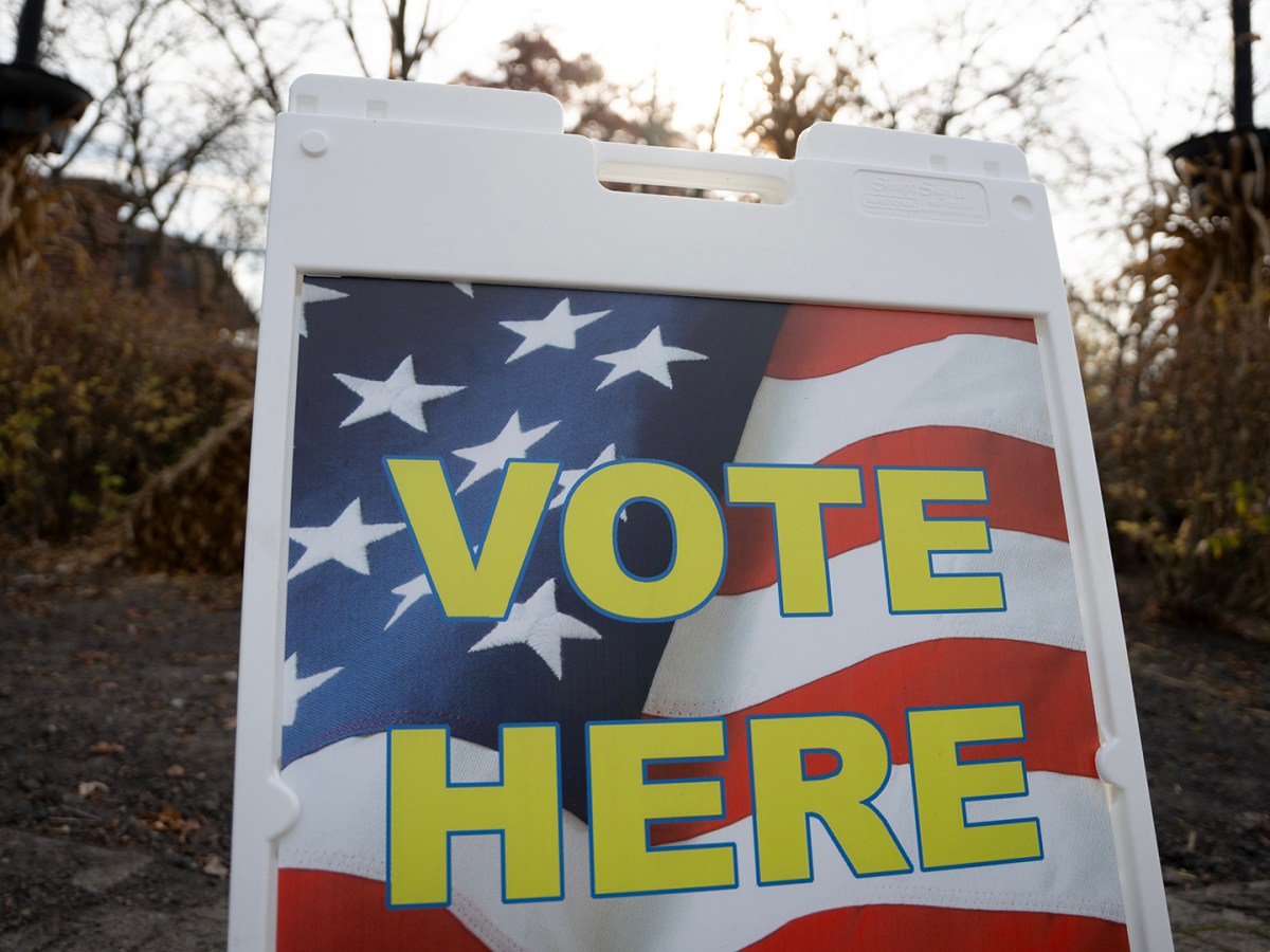 A sign that says "Vote Here."