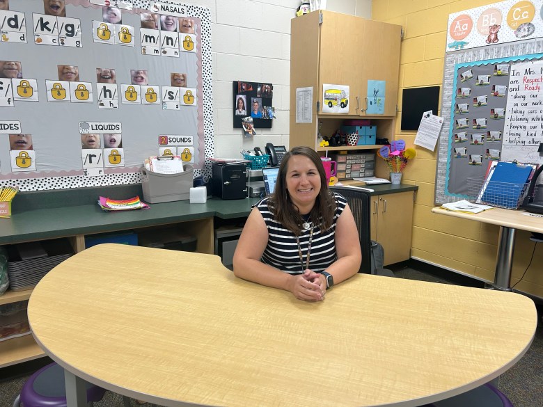 Heidi Winkler sits at her desk in her classroom.