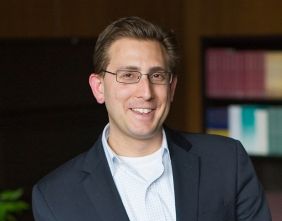 headshot of a smiling man