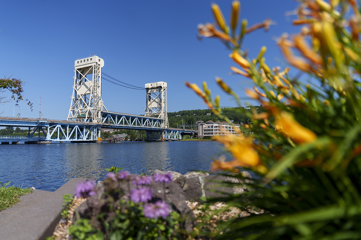 Portage Lake Lift Bridge in Houghton, Mich on a sunny day. You can see flowers as well.