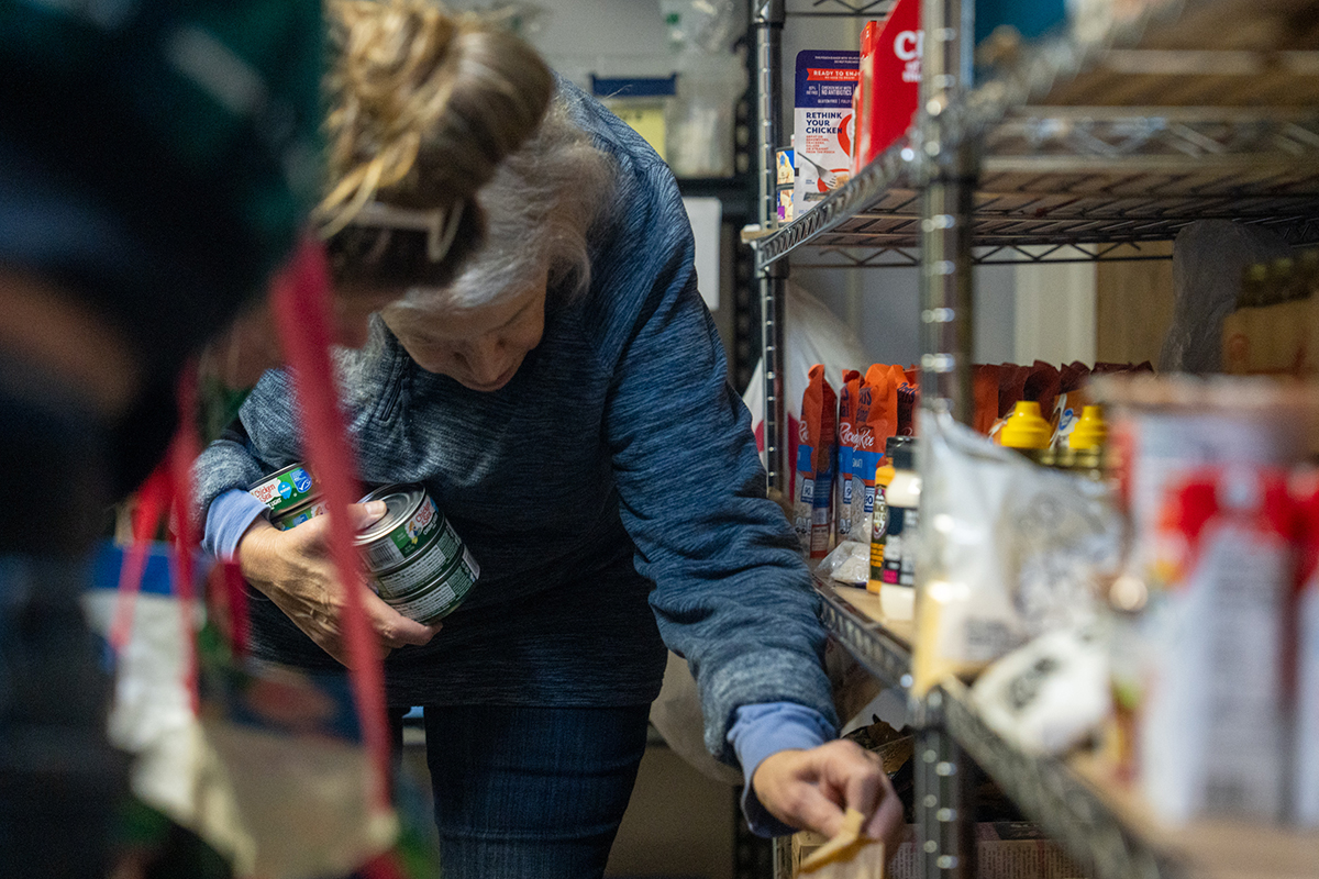 Volunteers help restock food and assist shoppers at the Elmwood Blessing Box in Westland, Michigan, on Wednesday, October 29, 2025.
