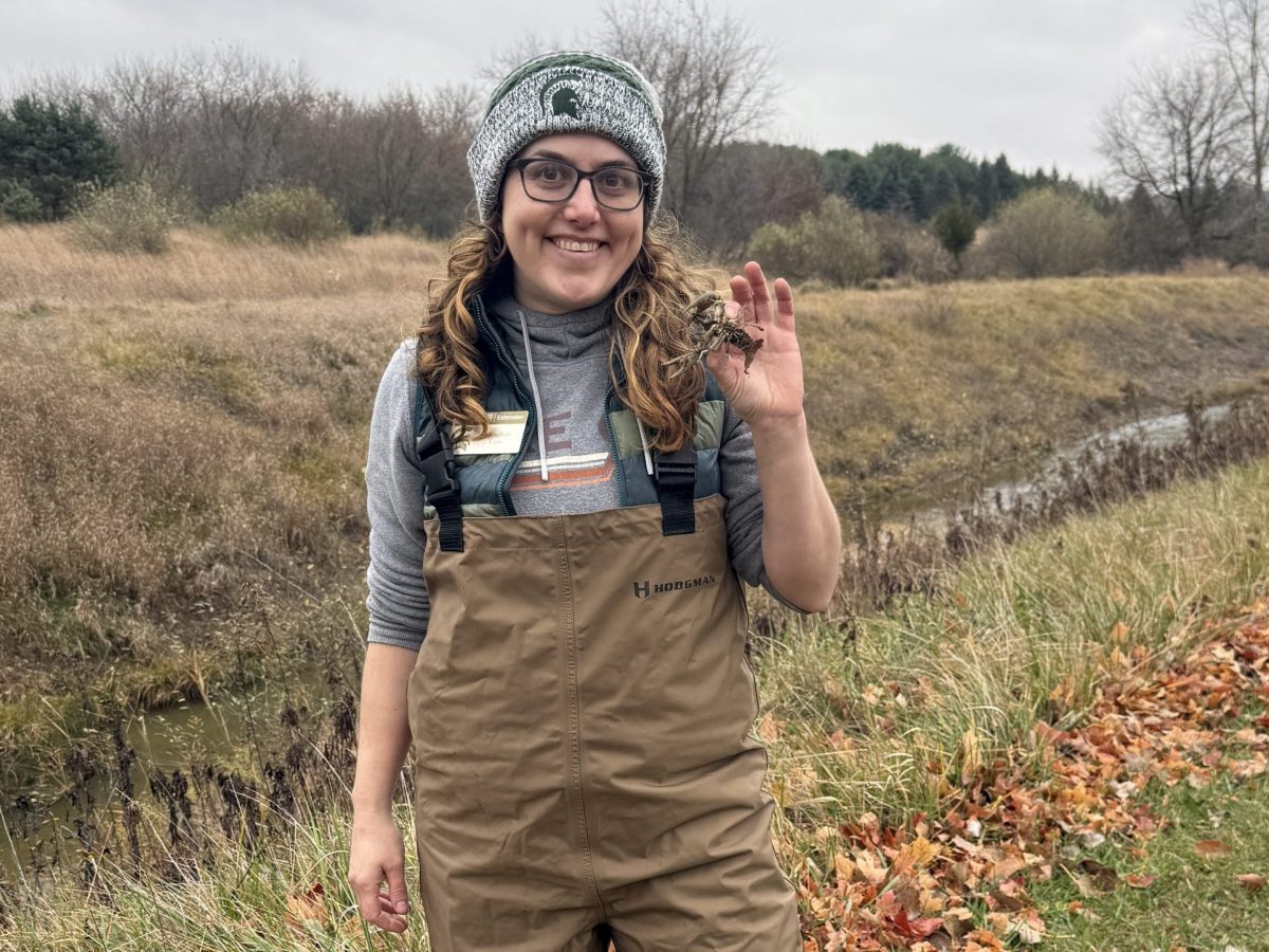 A woman holds a crayfish