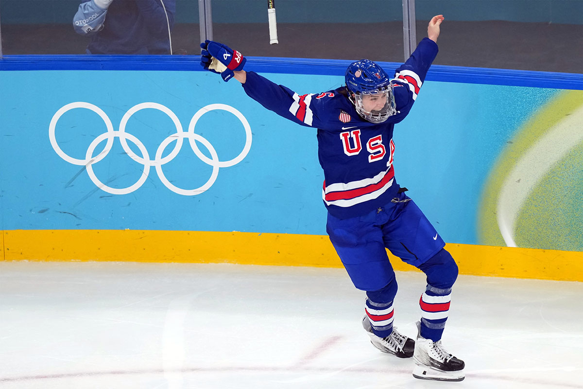 Megan Keller hands up in the air.