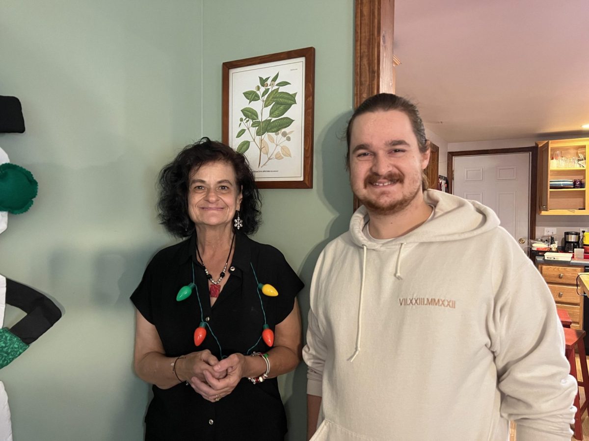A woman poses with an adult son