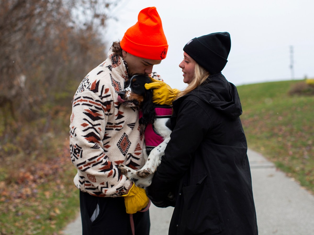 A couple with a dog.