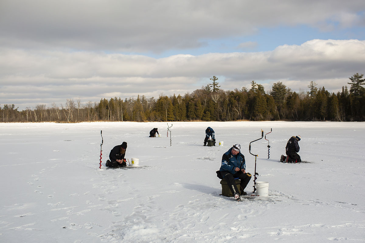 Five anglers on the frozen lake.