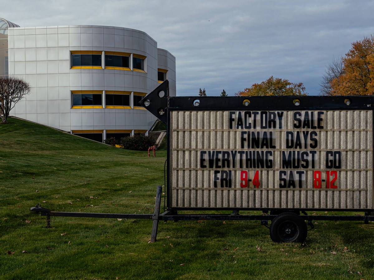 A sign that highlights a factory sale.
