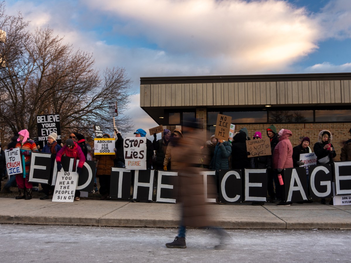 People holding anti-ICE signs.