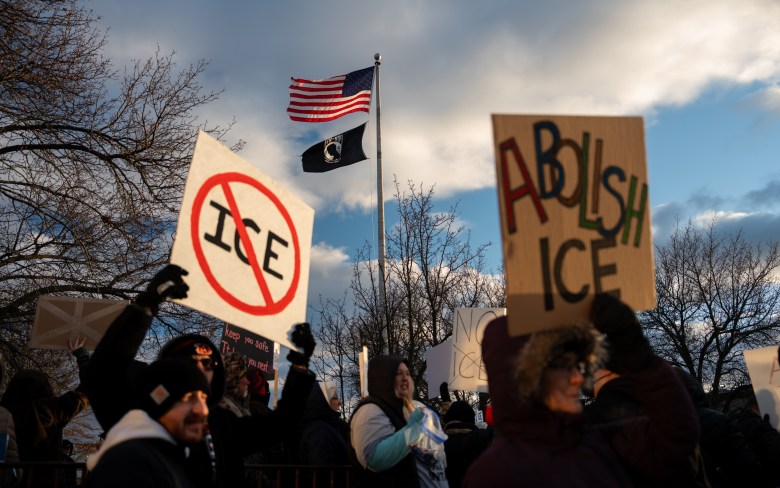 People holding anti-ICE signs. 