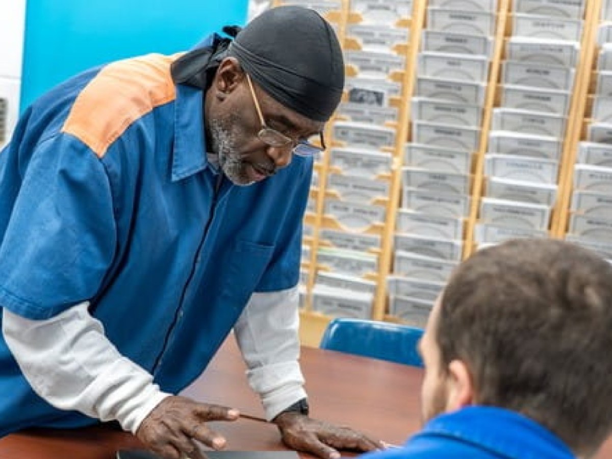 Two inmates talk a a table