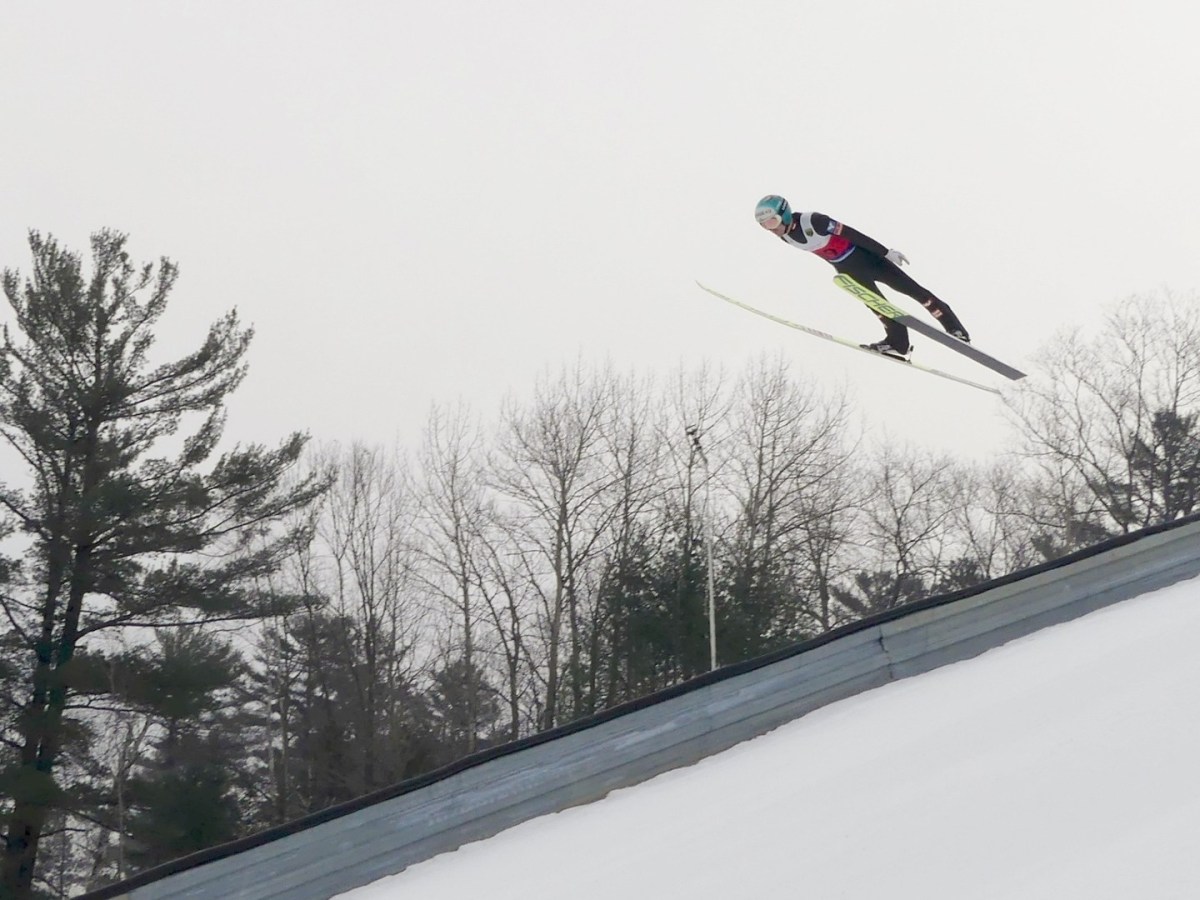 A ski jumper flies through the air