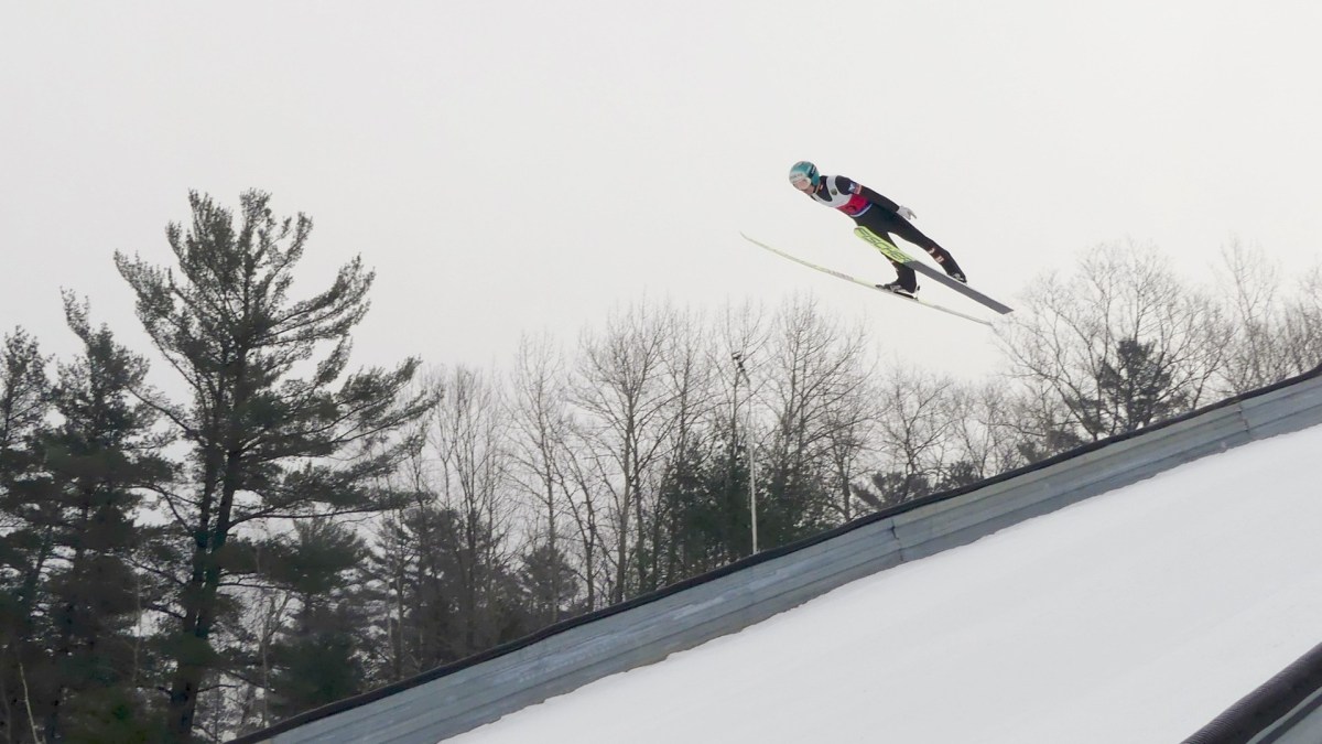 A ski jumper flies through the air