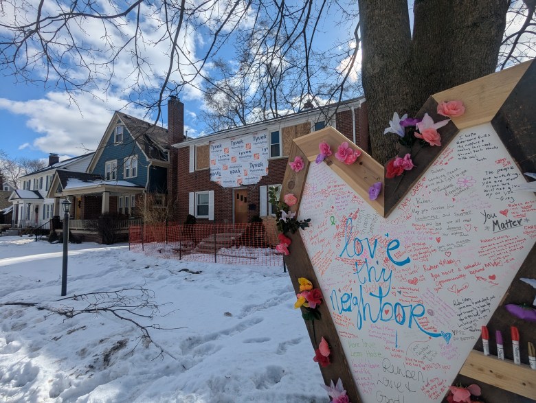 A heart-shaped board in front of a home. 