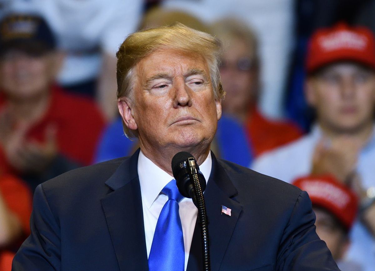 trump speaking into a microphone