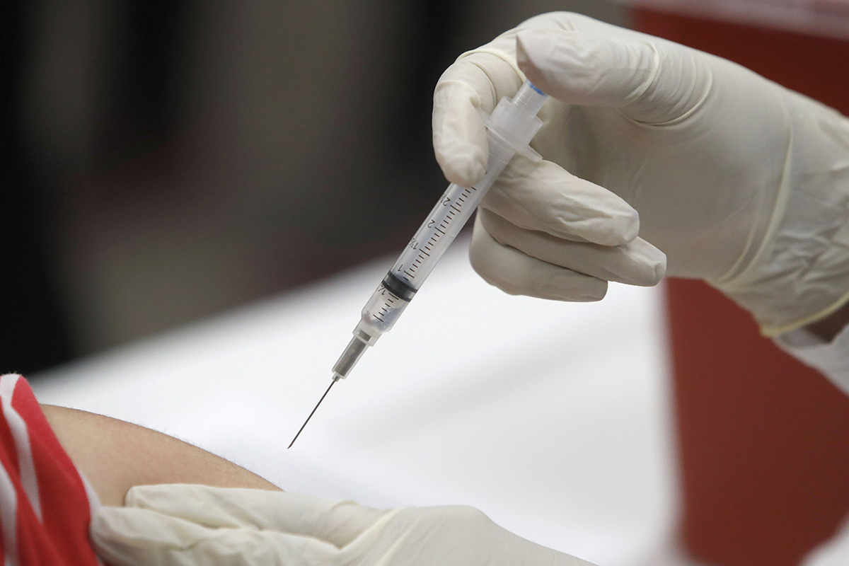 In this Thursday, Jan. 23, 2020, file photo, a patient receives an influenza vaccine in Mesquite, Texas.