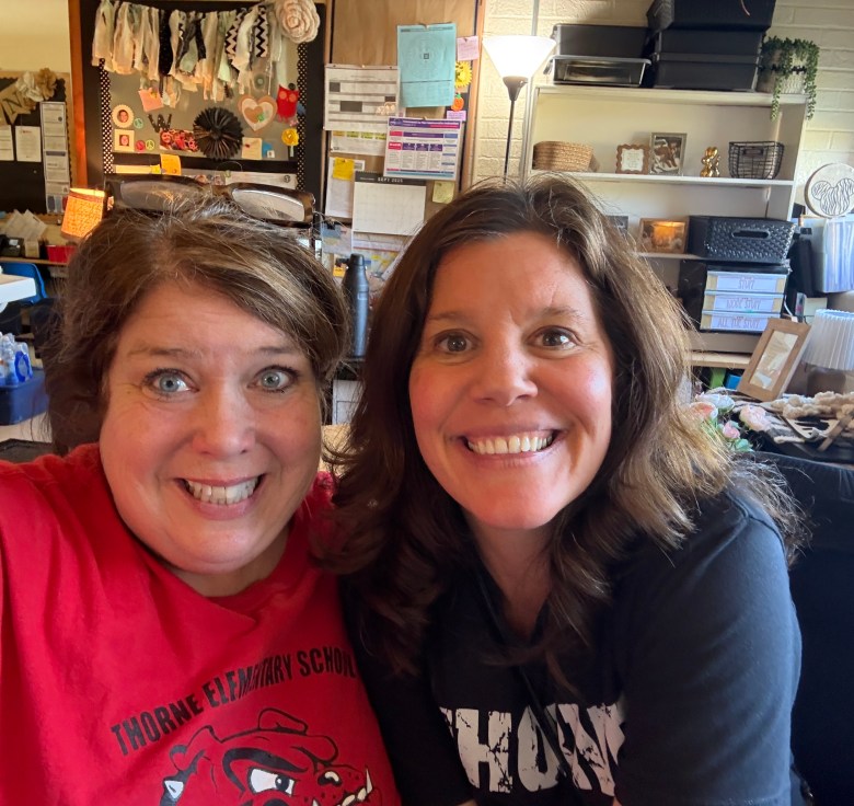 Jill Johnsen and Kim Metzger take a selfie in an office.